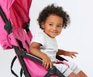 smiling baby in a stroller