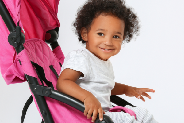smiling baby in a stroller