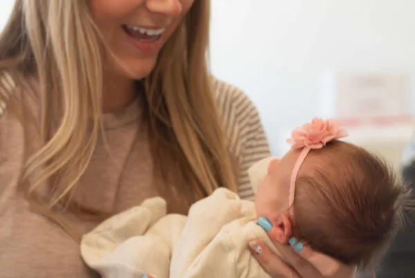 A mom in the Upper Peninsula holds her baby at an Rx Kids event