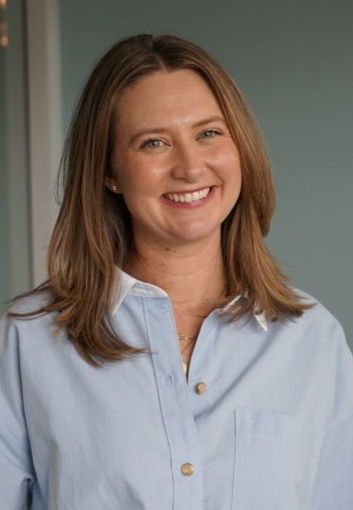 A smiling woman in a light blue shirt