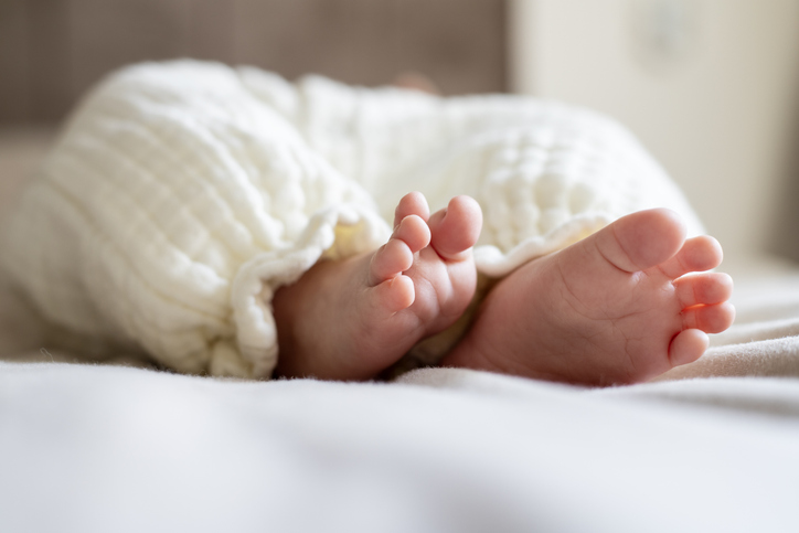 Two small newborn baby feet